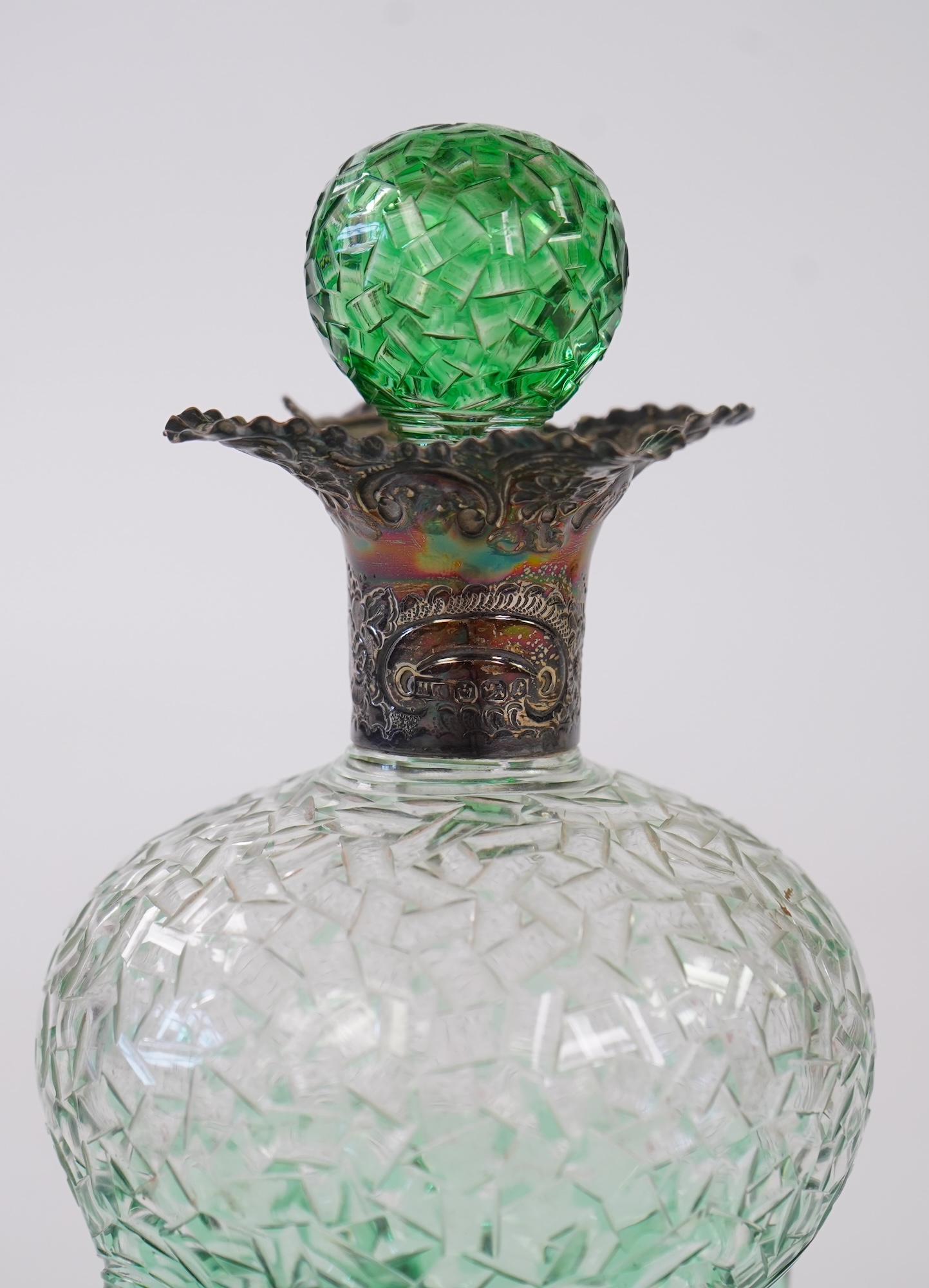 Attributed to Stevens and Williams of Stourbridge, a green flashed and cut pinched glass decanter